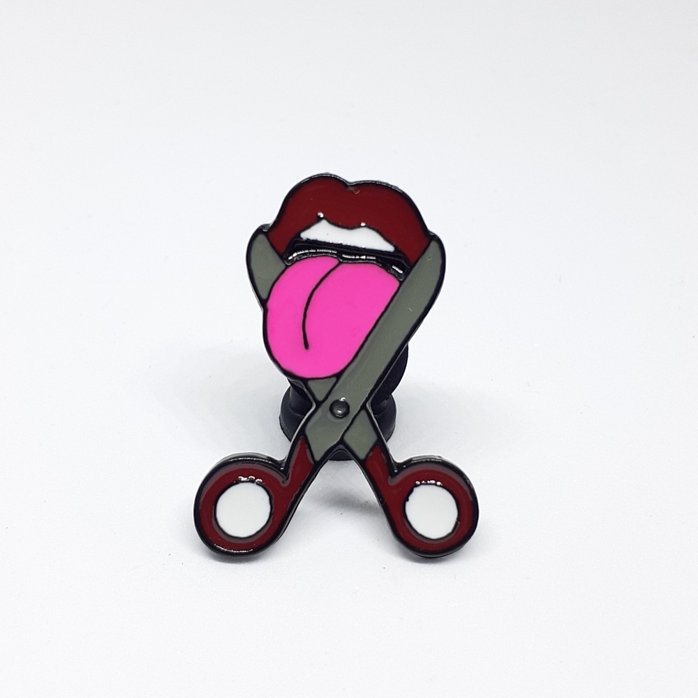 Cutting tongue enamel pin